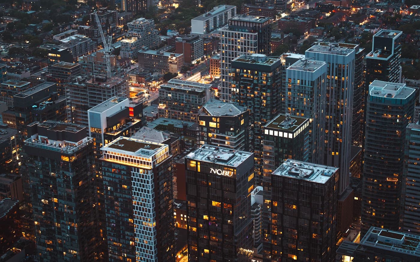 City skyline of office towers at dusk with lit windows