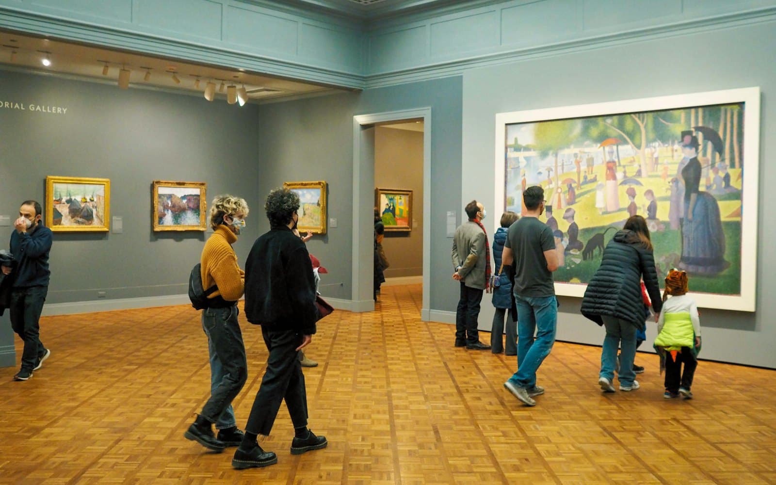 Visitors viewing paintings in an art gallery